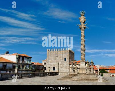 Portogallo, Porto, la colonna ornata, o pilloria (pelourinho) nella piazza del Duomo - il Terreiro da sé - con una torre medievale restaurata Foto Stock