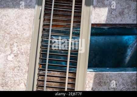 Pavimento piastrellato con coperchio di ventilazione HVAC a pavimento aperto rimosso Foto Stock