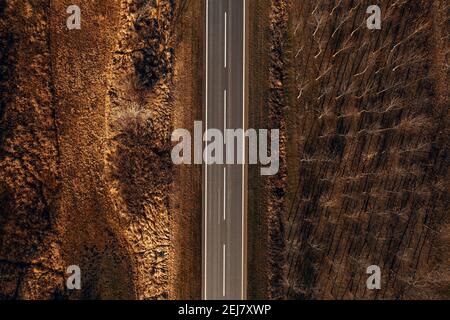 Strada vuota a due corsie dall'alto, fotografia con droni. Strada attraverso pianura paesaggio di campagna. Foto Stock