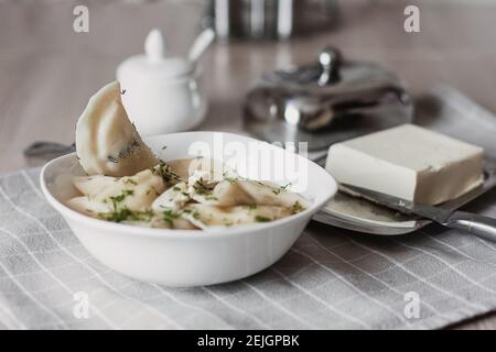 Gnocchi, ripieni di patate e serviti con burro e finocchio. Varenyky, vareniki, pierogi, pirohy. Gnocchi con riempimento Foto Stock