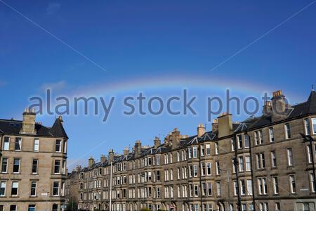 Edimburgo, Scozia, Regno Unito. 23 febbraio 2021. Una pausa temporanea nella nuvola di mezzogiorno e le docce danno luogo ad un arcobaleno sopra i tetti residenziali del centro della città. Credit: Craig Brown/Alamy Live News Foto Stock