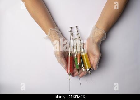 Medico che tiene una siringa con un medicinale Foto Stock