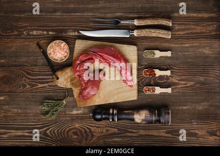 Vista dall'alto della striscia di manzo rotonda con top fresco crudo spezie Foto Stock