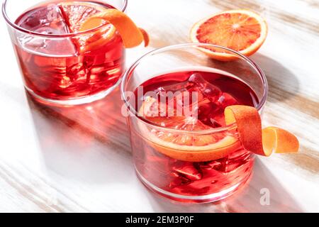 Cocktail Negroni con arance di sangue, su sfondo ligneo Foto Stock