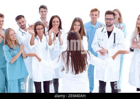 capo medico di fronte ai suoi colleghi applaudenti Foto Stock