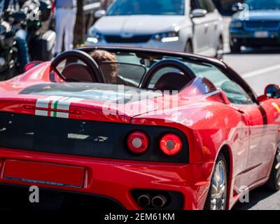 Auto sportiva rossa nel traffico stradale. Stile vintage Foto Stock