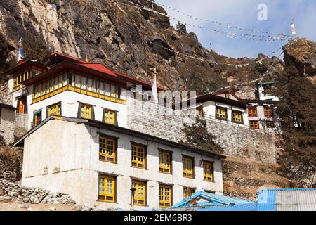 Thame gompa con bandiere di preghiera e simboli buddisti - monastero nella valle di Khumbu su tre passi trekking, Monte Everest zona, Sagarmatha parco nazionale, NE Foto Stock