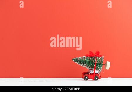 Un'auto giocattolo porta un albero di Natale Foto Stock