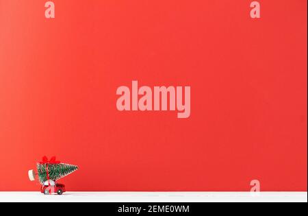 Un'auto giocattolo porta un albero di Natale Foto Stock