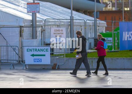 Preston, Lancashire. 25 Febbraio 2021. Volontari che assistono al centro NHS Covid 19 Vaccination Service. Programmi nazionali di vaccinazione nel Regno Unito in cui l'assorbimento del vaccino segnalato è stato inferiore in aree con una percentuale più elevata di gruppi etnici di minoranza che hanno meno probabilità di assumere un jab di coronavirus. Credit: MediaWorldImages/AlamyLiveNews. Foto Stock