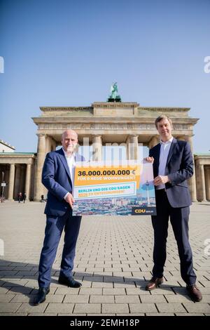 25 febbraio 2021, Berlino: Kai Wegner (l), presidente di Stato della CDU-Berlino, e Stefan Evers, segretario generale della CDU-Berlino, stanno con un cartello di fronte alla porta di Brandeburgo durante una sessione fotografica a seguito di una conferenza stampa della CDU di Berlino sulla petizione per un referendum "espropriato Deutsche Wohnen & Co". Il CDU di Berlino critica la socializzazione degli appartamenti delle società di alloggi privati, come previsto dalla petizione per un referendum. Foto: Christoph Soeder/dpa Foto Stock