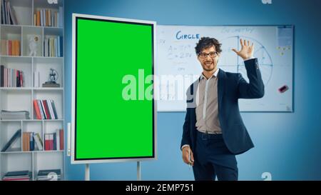 Portrait of friendly Teacher spiega la lezione a un'aula, utilizza una lavagna digitale con schermo verde. Un uomo d'affari di successo parla della crescita del progetto Foto Stock