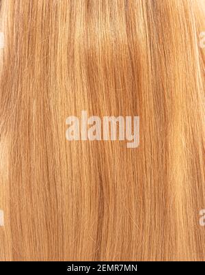 Capelli biondi femminili come primo piano di sfondo. Foto Stock