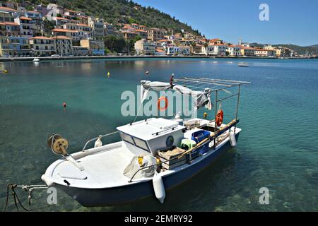 Seascape con una pittoresca barca da pesca greca e vista sull'architettura neoclassica di Gytheio, Laconia Grecia. Foto Stock