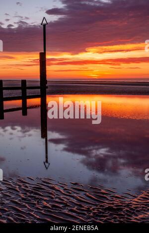 Tramonto sulla spiaggia di Rhyl a bassa marea a nord Costa del Galles Foto Stock