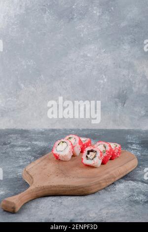 California Rolls con caviale di pesce volante su tavola di legno Foto Stock