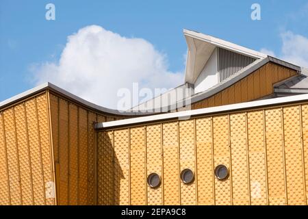 Curve astratte e pareti gialle della Philharmonic Hall in contrasto con un cielo blu a Berlino, in Germania. Foto Stock