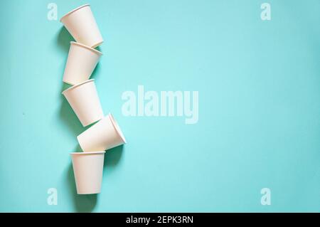 i vasetti di carta bianca monouso kraft si trovano su sfondo blu di carta Foto Stock