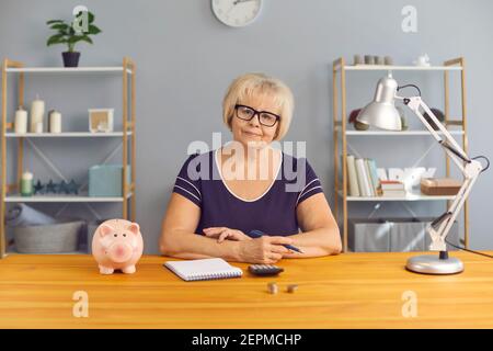 Sorridente ragioniere di donna matura che guarda la macchina fotografica durante la riunione in linea Foto Stock