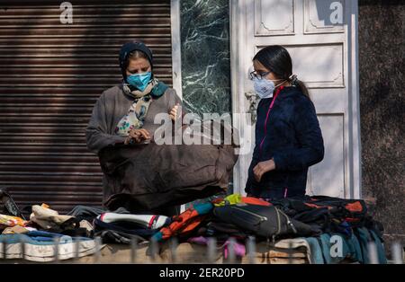 Srinagar, Kashmir controllato dall'India. 28 Feb 2021. Le donne che indossano le maschere facciali fanno acquisti in un mercato nella città di Srinagar, la capitale estiva del Kashmir controllato dagli Indiani, il 28 febbraio 2021. Credit: Javed Dar/Xinhua/Alamy Live News Foto Stock