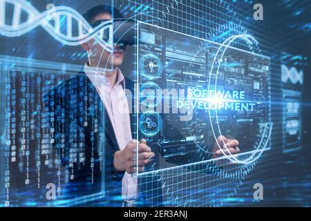 Business, tecnologia, Internet e concetto di rete. Giovane uomo d'affari che lavora su uno schermo virtuale del futuro e vede l'iscrizione: Software dev Foto Stock