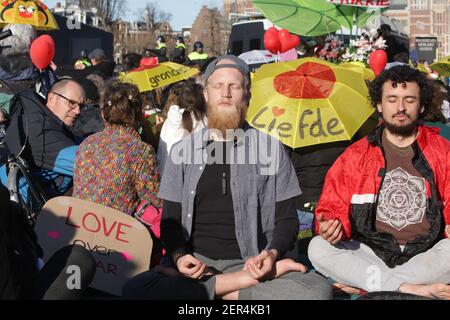 Amsterdam, Paesi Bassi. 28 Feb 2021. Due sostenitori dell'Anti-Lockdown meditano durante la protesta contro le misure del coronavirus in occasione della pandemia del coronavirus alla Museumplein il 28 febbraio 2021 ad Amsterdam, Paesi Bassi. Il sindaco di Amsterdam Femke Halsema ha classificato la Museumplein come "area di rischio della sicurezza", dando ai poliziotti il diritto di controllare e cercare chiunque in quella zona per prevenire la dimostrazione illegale e il vandalismo. (Foto di Paulo Amorim/Sipa USA) Credit: Sipa USA/Alamy Live News Foto Stock