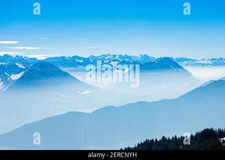 Vista panoramica unica dello skyline alpino dal paesaggio aereo delle nebbie cime ghiacciate delle Alpi svizzere in cielo blu. Monte Rigi Svizzera in primavera. Concetto di viaggio. Foto Stock