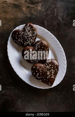 Biscotti a forma di cuore al cioccolato fondente. Foto Stock