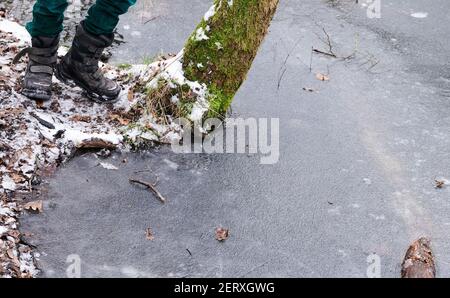 02 febbraio 2021, Brandeburgo, Birkenwerder: Un bambino si erge sulla radice innevata di un albero che si stacca nel Briese mezzo-congelato. Il Briese è un piccolo affluente del Havel. Con la sua vista impressionante, la palude nella valle Briese è un popolare sentiero escursionistico e luogo per i fotografi amatoriali. Foto: Annette Riedl/dpa-Zentralbild/ZB Foto Stock