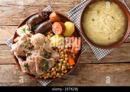 Tradizionale spagnolo Comfort Food a casa Cocido Madrileno primo piano su un piatto sul tavolo. Vista orizzontale dall'alto Foto Stock