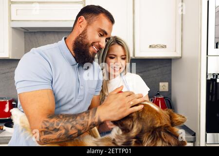 Cucina di coppia amorevole con il loro bordo Collie cane Foto Stock