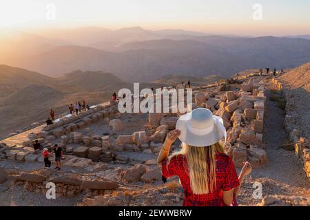 Girl guarda il tramonto sulla cima del monte Nemrut, ad Adiyaman, Turchia. Foto Stock