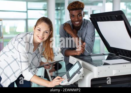 felici due lavoratori e la manutenzione della stampante Foto Stock