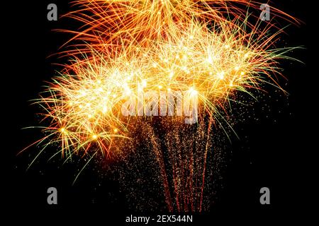 Immagine con sfondo nero preparata per modificare il testo di un fuochi d'artificio, formato da un grande burst di stelle e punti di colore arancione, rosso, giallo e verde Foto Stock