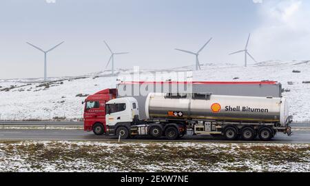 Vagoni che viaggiano a sud sull'autostrada M6 attraverso Cumbria vicino allo svincolo 37, con Lambiggs Wind Farm sullo sfondo. Cumbria, Regno Unito. Foto Stock