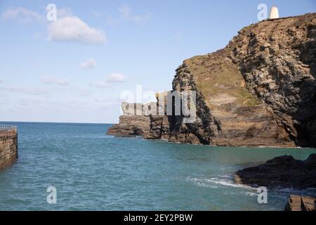 Il sole glorioso sopra le scogliere e l'entrata del porto in Portreath, Cornovaglia Foto Stock