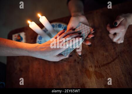 scegli una carta dalle mani di un cassiere di fortuna. una donna racconta le fortune durante un rituale magico. credenza nel misticismo Foto Stock