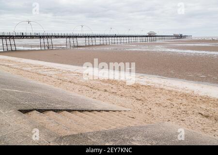 I gradini conducono dalla passeggiata alla spiaggia sabbiosa di Southport, catturata nel marzo 2021 durante la pandemia di Covid. Foto Stock