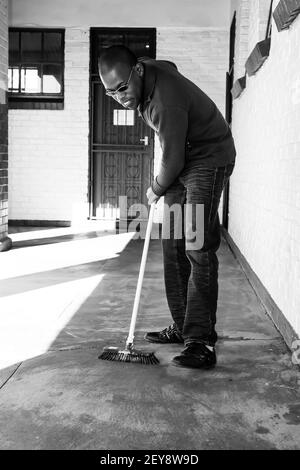 JOHANNESBURG, SUD AFRICA - 05 gennaio 2021: Soweto, Sud Africa - 21 luglio 2012: Uomo africano che esegue il servizio di comunità volontariato di pulizia a t Foto Stock