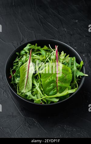 Rucola raab e Mangold, bietole svizzere, su fondo di pietra nera Foto Stock