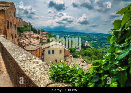 Incredibile paesaggio urbano con rustiche case in pietra e vista pittoresca dalle mura di Montepulciano, Toscana, Italia, Europa Foto Stock