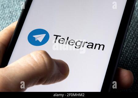 Telegramma Messenger, l'applicazione di messaggistica più veloce sul mercato, visualizzata sullo schermo di uno smartphone, con le dita. Foto Stock