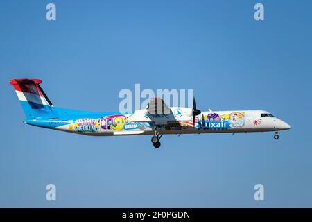 Luxair Bombardier DHC-8-400 con la registrazione LX-LQA in aereo Avvicinati alla pista meridionale 08R dell'aeroporto di Monaco EDDM MUC Foto Stock