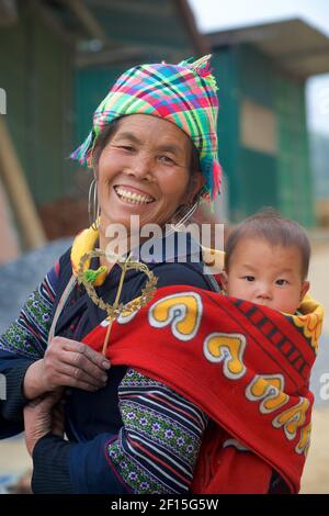 Donna vietnamita che porta il bambino sulla schiena, Sapa, provincia di Lao Cai, Vietnam settentrionale. Tribù delle colline di Hmong. Foto Stock