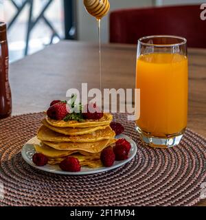 Frittelle con mora, lampone, fragola, menta e miele Foto Stock