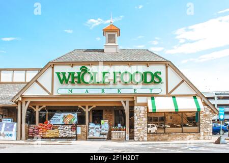 07 14 2020 Tulsa USA Whole Foods Market con borse e piante e deposito del ghiaccio fuori davanti e automobili ed edifici riflettuto in finestre Foto Stock