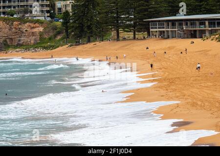 Avalon Beach a Sydney giorno d'autunno e le persone si allenano La spiaggia a piedi passando il club di surf, Sydney, Australia Foto Stock