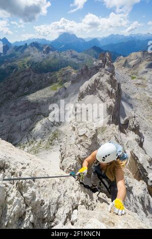 Attraente scalatore femminile su una ripida Via Ferrata nel Dolomiti Italiane Foto Stock