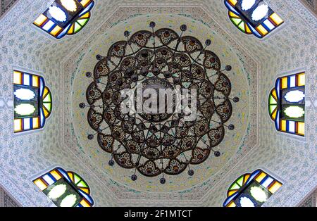 Vista dal basso del soffitto con finestre in vetro colorato e molti ornamenti e dettagli in un tradizionale stile orientale. Foto Stock