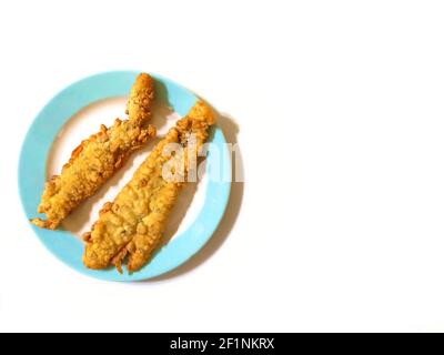 Un colpo di filetto di pesce fresco e fritto in pastella su una piastra isolata su uno sfondo bianco con copyspace Foto Stock